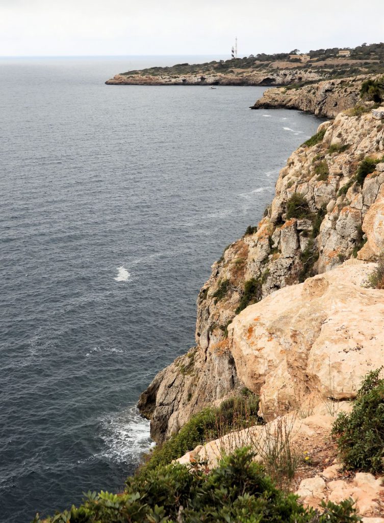 Sandstone rock cliffs and the Cala Figuera lighthouse.